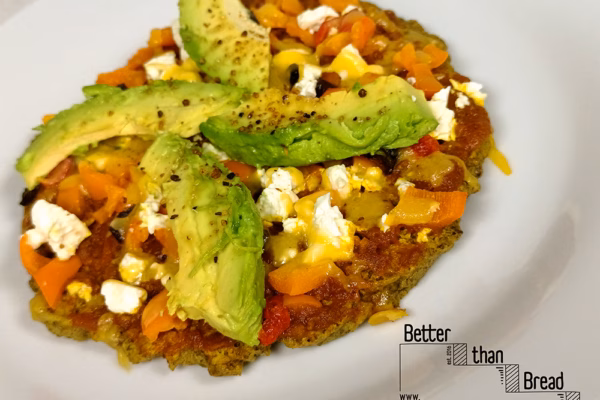 Healthy Pizza Exists: Using our Better Than Bread seed and egg based mixture, topped with tomato chutney, peppers red and yellow, peppadews,feta, olives, and avocado slices - on a Small Pizza for 1.